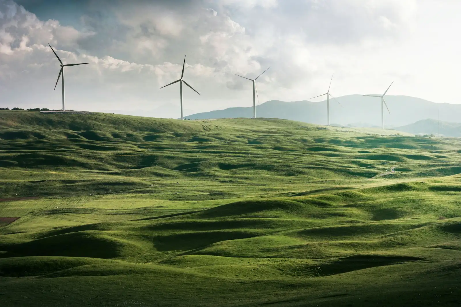 Wind turbines on green rolling hills